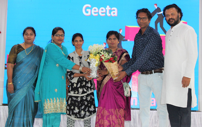 Geeta receiving flowers with Progressive Life Center supporters at a community event